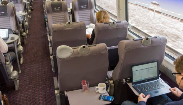 People working on laptops on Grand Central trains