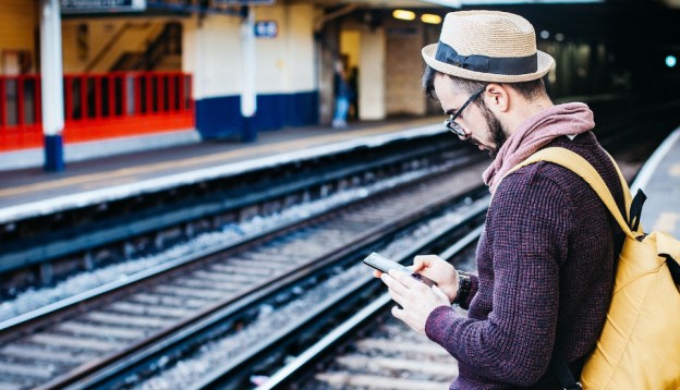 Man checking train times on Grand Central app