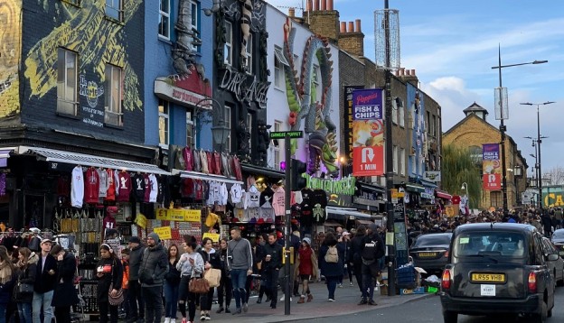 Vibrant vintage clothes shops in Camden with Camden Lock in background